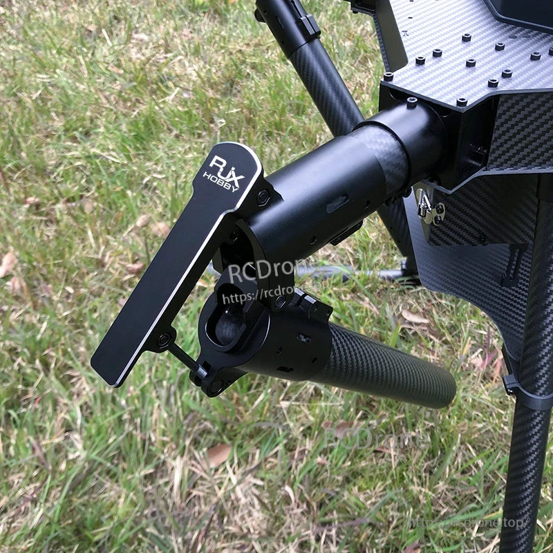 Close-up of RJX1300C carbon fiber quadcopter frame arm with folding hinge, motor mount, and propeller