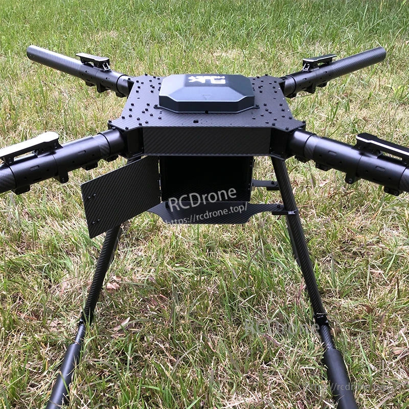 Large carbon fiber folding quadcopter frame with four arms, central top plate, and tall landing gear