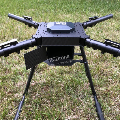 Large carbon fiber folding quadcopter frame with four arms, central top plate, and tall landing gear