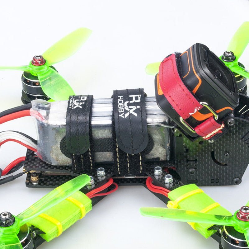 RJXHOBBY RJX Non-Slip Silicone Battery Strap, Black RJXHOBBY non-slip silicone battery strap holding a LiPo pack on a quadcopter frame