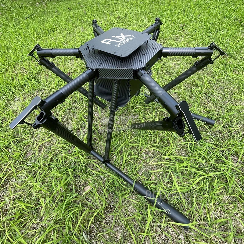 RJX1850A carbon fiber folding hexacopter frame with umbrella-style arms and dual deck plates on grassy ground