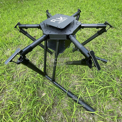 RJX1850A carbon fiber folding hexacopter frame with umbrella-style arms and dual deck plates on grassy ground