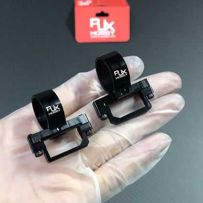 Pair of RJXHOBBY XT90 plug fixed seat mounts in black, shown in hand with clamp-style bases