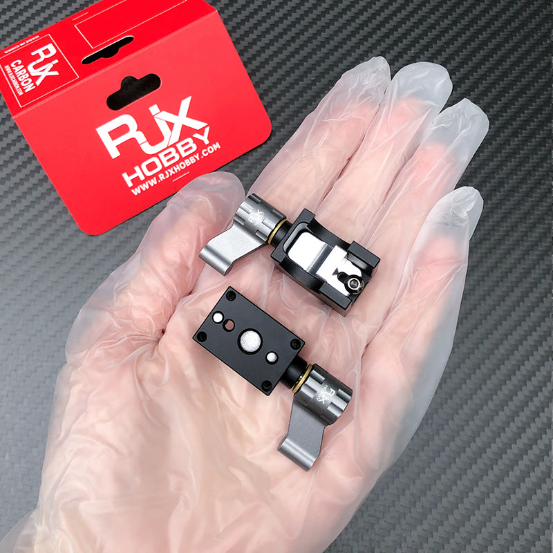 RJX 2pcs Tarot Mount, Two RJX Hobby Tarot-style metal mounts with black clamp blocks and silver arms on a hand