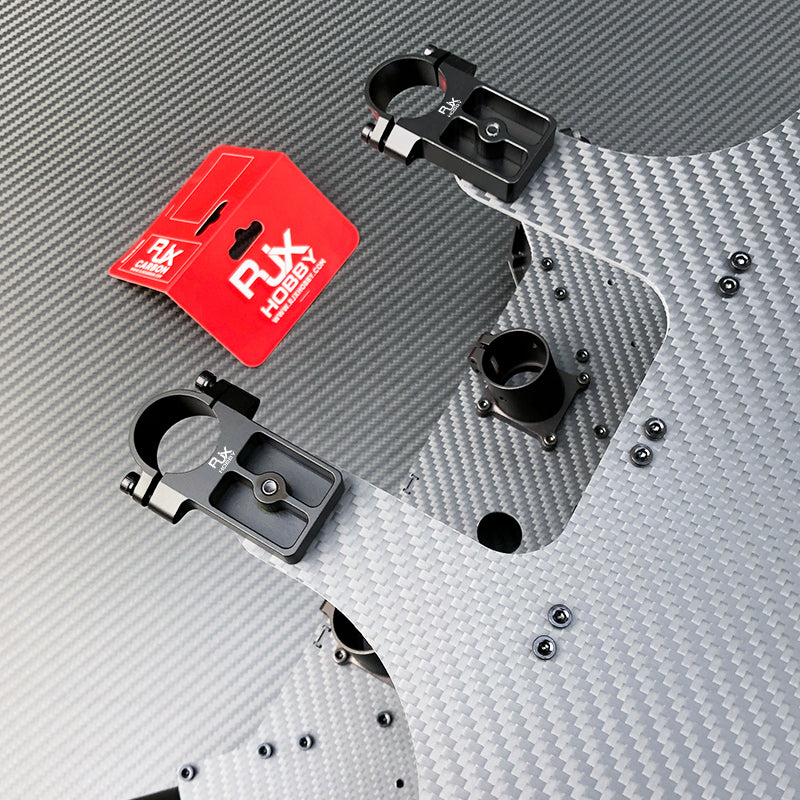 RJX UAV drone tube mounts with black clamp brackets installed on a carbon fiber frame plate