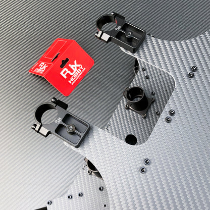 RJX UAV drone tube mounts with black clamp brackets installed on a carbon fiber frame plate