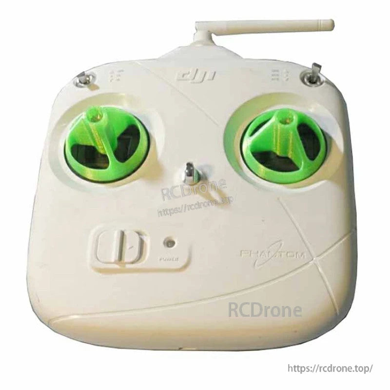White DJI Phantom RC transmitter with green rocker safety covers installed over both control stick gimbals