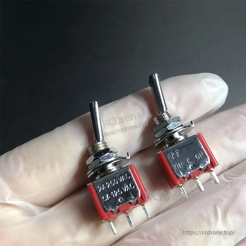 Two metal toggle switches with red housing and threaded mounting nuts, 2-position RC transmitter reset switches