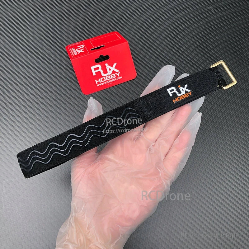 RJXHOBBY black non-slip silicone battery strap with stitched edges and gold metal buckle, with red packaging