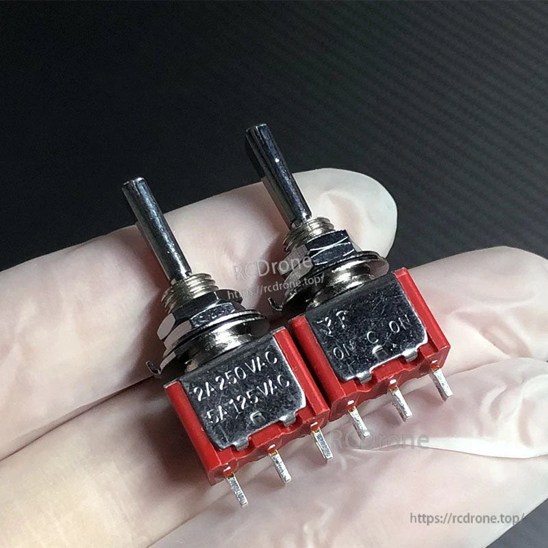 RJXHOBBY 2pcs 3-Position Reset Switch, Two mini 3-position toggle reset switches with red housings and 3-pin terminals, rated 2A 250VAC/5A 125VAC.