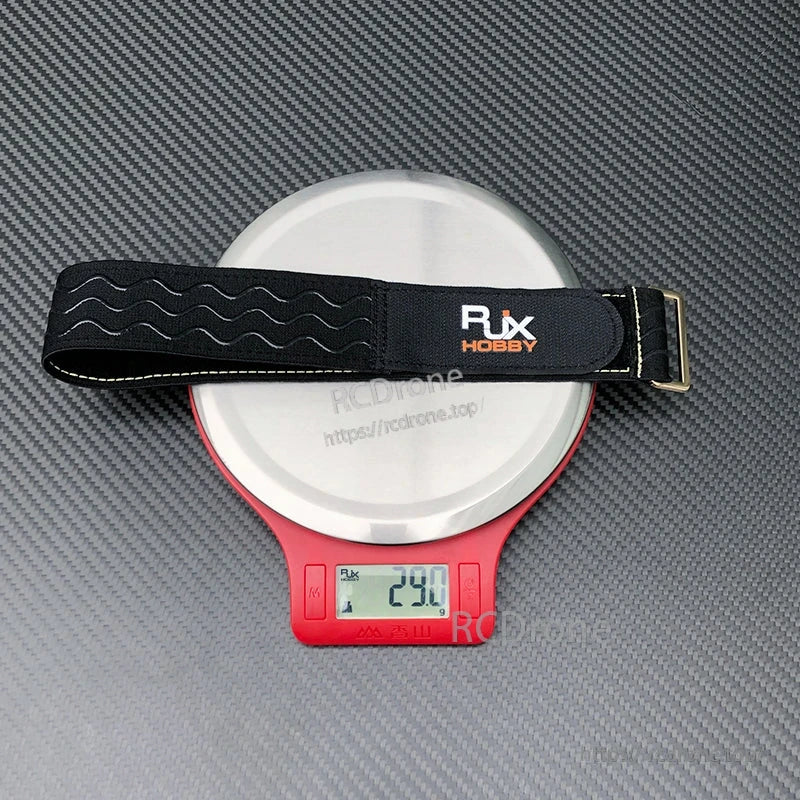 RJXHOBBY black non-slip silicone battery strap with stitched edges and metal buckle, weighing 29g on scale