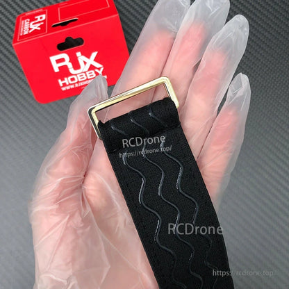 RJXHOBBY black non-slip silicone battery strap with wavy grip lines and metal buckle, in hand