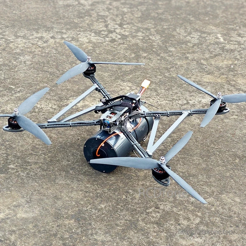 FPV quadcopter drone with a large cylindrical fiber-optic spool mounted underneath the frame