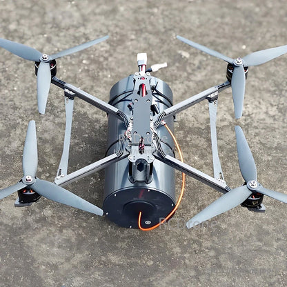 FPV quadcopter with a large fiber-optic data link spool mounted underneath and an orange tether line attached