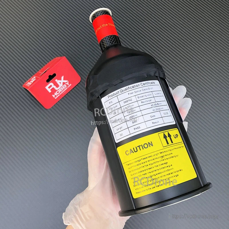 RJXHOBBY fiber optic cable spool in protective drum with G657A2 qualification label and caution sticker
