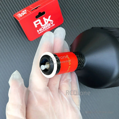 RJXHOBBY fiber-optic data link spool module with red label and black spool housing, close-up of connector end
