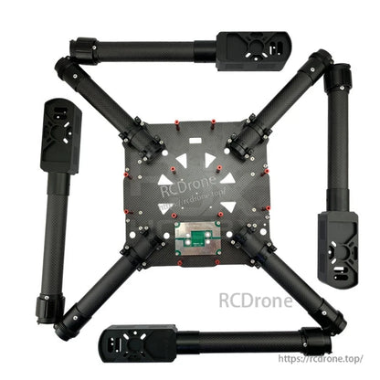 Aluminum clip-style tube clamp mounted on a carbon fiber drone arm, securing a 30mm round tube joint
