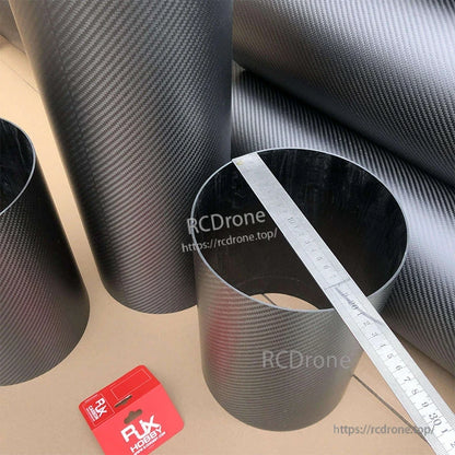 RJXHOBBY 3K Carbon Fiber Round Tube, 3K carbon fiber round tube with twill weave finish, shown with a ruler across the opening for size reference