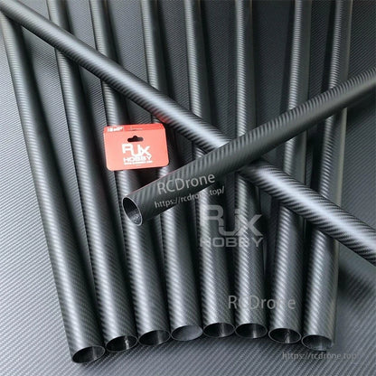 RJXHOBBY 3K carbon fiber round tube with twill weave finish, hollow interior, shown among multiple tubes
