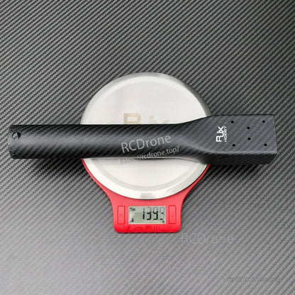 RJXHOBBY 40x36x300mm carbon fiber multicopter arm with D40mm tube resting on a digital scale reading 139.9g