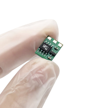 Micro brushed RC ESC module on a tiny green PCB held between gloved fingers for scale