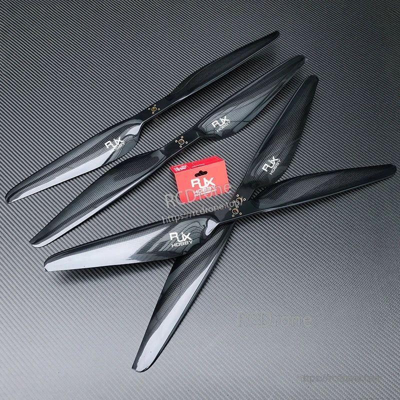 RJXHOBBY carbon fiber propeller set with two- and three-blade props on a textured dark surface