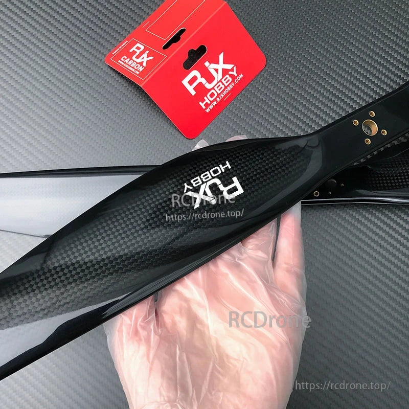 RJXHOBBY carbon fiber propeller with glossy black finish and visible weave pattern for RC aircraft