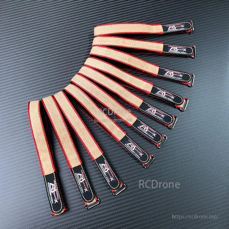 RJXHOBBY Kevlar battery straps with red edging and metal buckles, bundled together on a textured surface