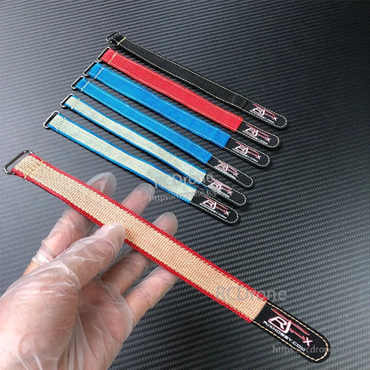RJXHOBBY Kevlar Battery Strap, RJXHOBBY-style Kevlar battery strap with metal buckle, shown in multiple colors on a carbon-fiber surface