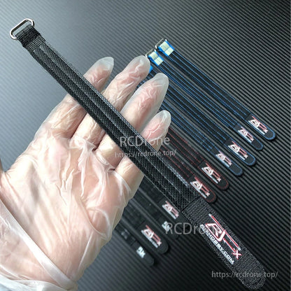 RJXHOBBY Kevlar battery strap with metal buckle and woven black webbing, shown alongside multiple strap sizes