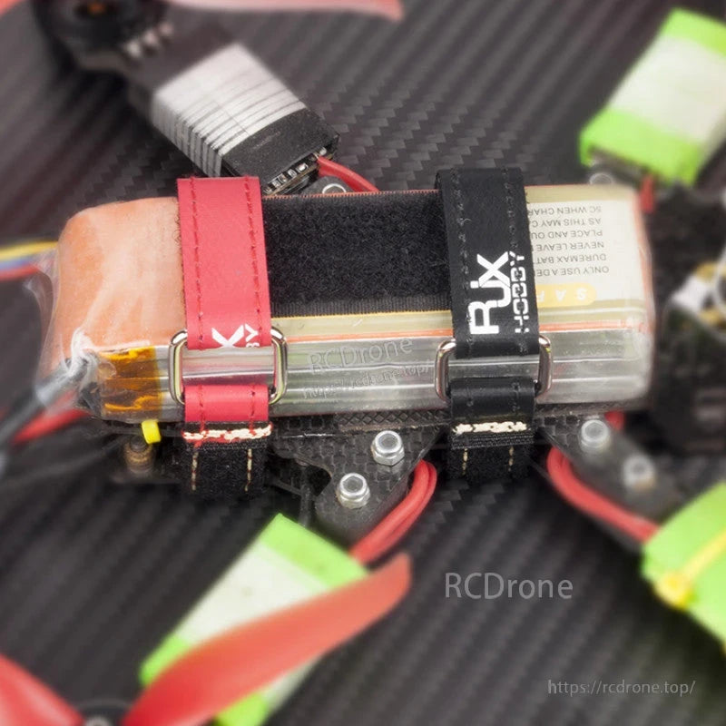 RJXHOBBY Kevlar Stitched Battery Strap, RJXHOBBY Kevlar stitched hook-and-loop battery strap with metal buckle securing a LiPo pack on an FPV drone