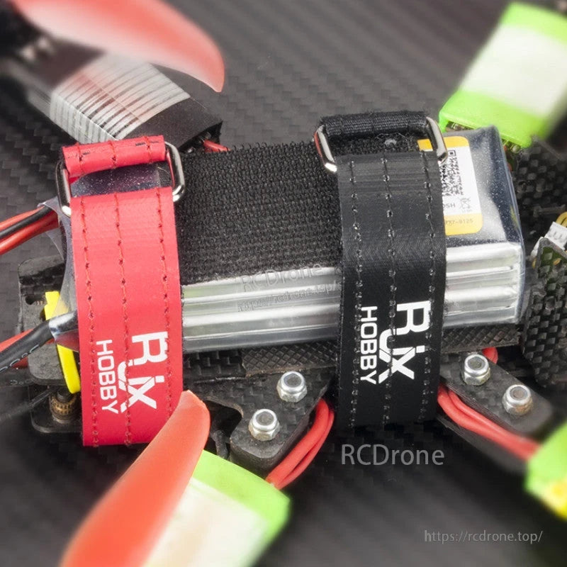 RJXHOBBY Kevlar Stitched Battery Strap, RJXHOBBY stitched battery straps with metal buckles securing a LiPo battery on an FPV drone frame