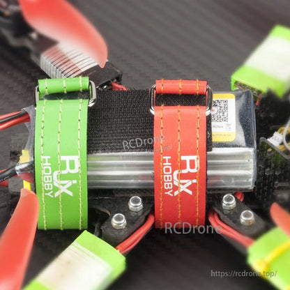 RJXHOBBY Kevlar Stitched Battery Strap, Stitched RJXHOBBY battery straps with metal buckles securing a LiPo battery on an FPV drone frame