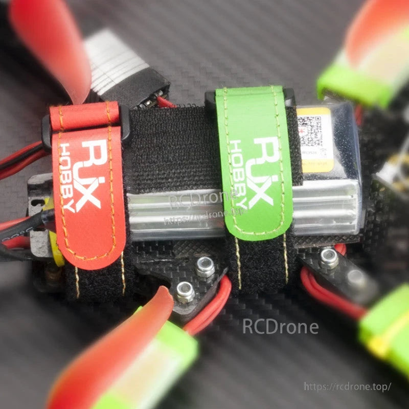 RJXHOBBY Non-Slip Silicone Battery Strap, RJXHOBBY battery straps in red and green securing a LiPo battery on an FPV drone frame