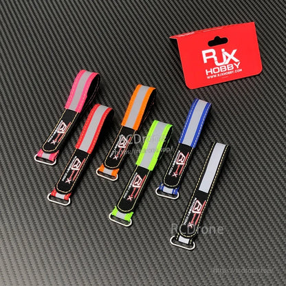 RJXHOBBY Reflective Battery Strap 2pcs, RJXHOBBY reflective battery straps with metal buckles in assorted colors on a carbon fiber background