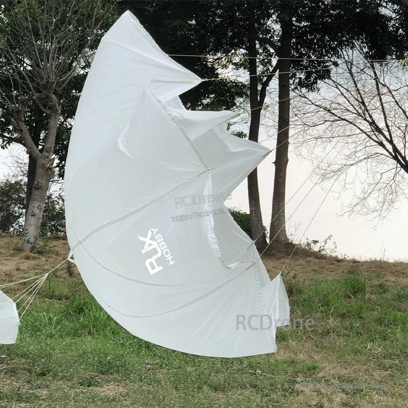 White RJXHOBBY UAV parachute canopy with suspension lines deployed outdoors