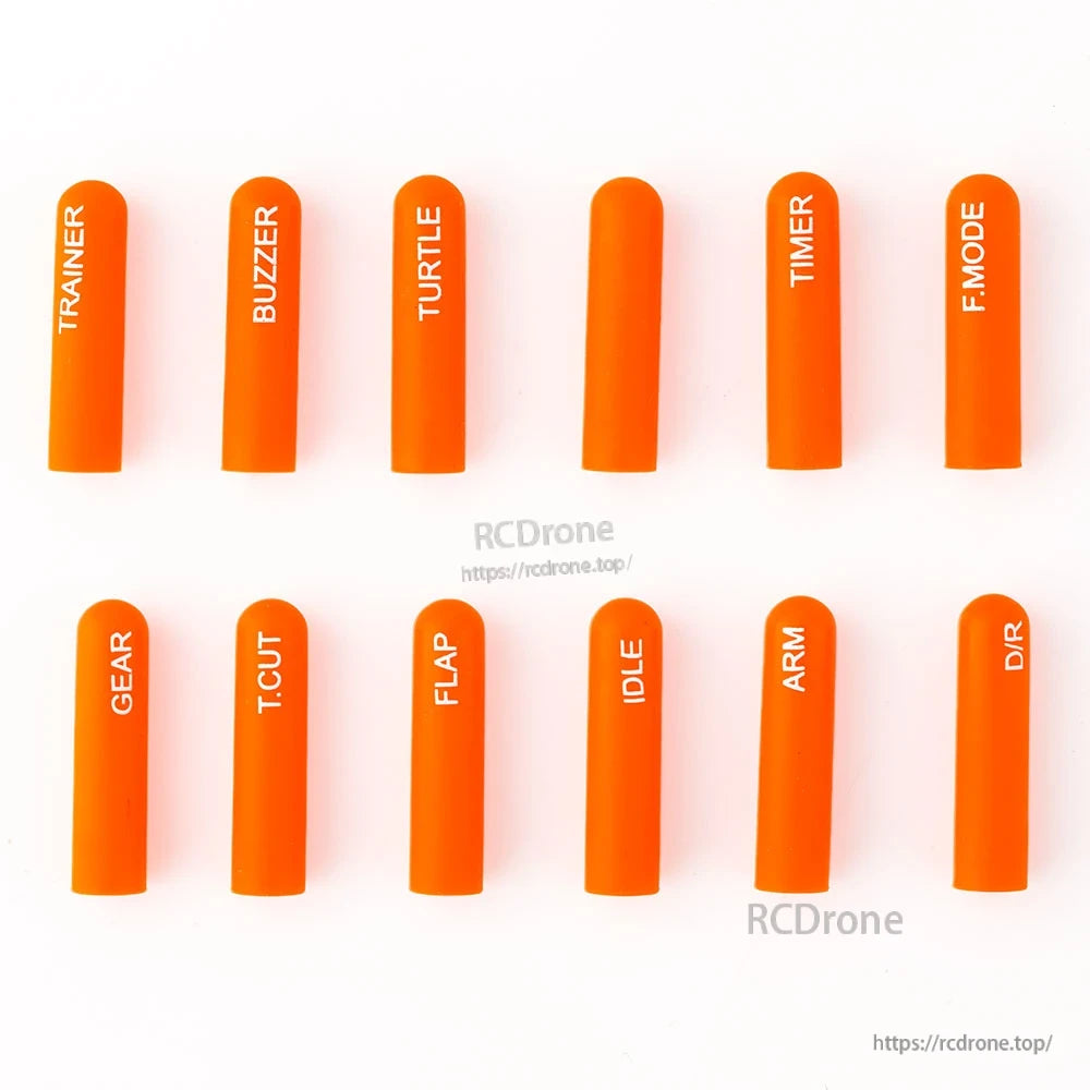 Orange long labeled silicone switch covers, 12-piece set laid out on white background
