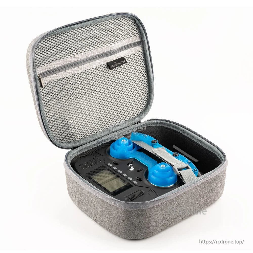 Open gray RadioMaster case showing mesh zippered lid pocket and fitted compartment holding Boxer radio