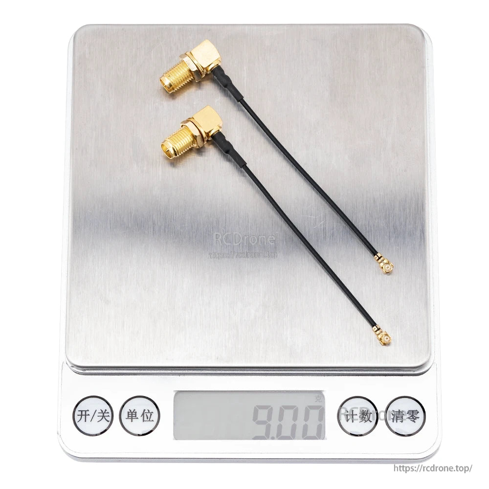 Two RP-SMA right-angle pigtail cables on digital scale display reading 9.00