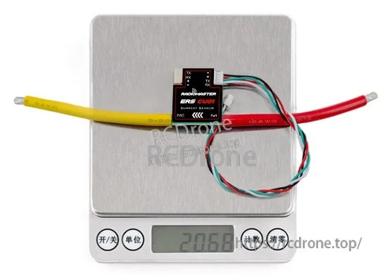 ERS-CU01 current sensor on digital scale displaying about 20.6 g with attached leads and cable