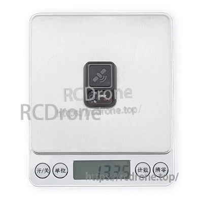 ERS-GPS sensor on digital scale showing approximately 13.35 g weight