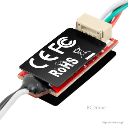 Angled rear view of module with heatshrink cable exit and white multi-pin connector