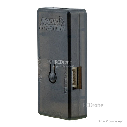 Angled view of RadioMaster ELRS USB UART flasher V2 showing side RX/TX header opening and POWER button