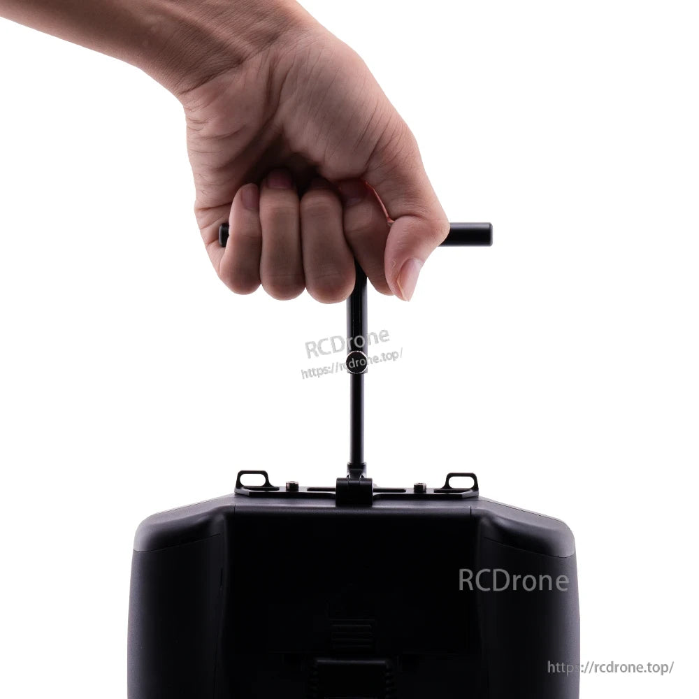 Hand gripping the T-handle on the mounted stand to carry the radio controller