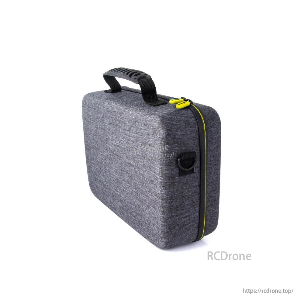 Side profile of gray fabric carry case showing zipper track, yellow pulls, and D-ring strap mount