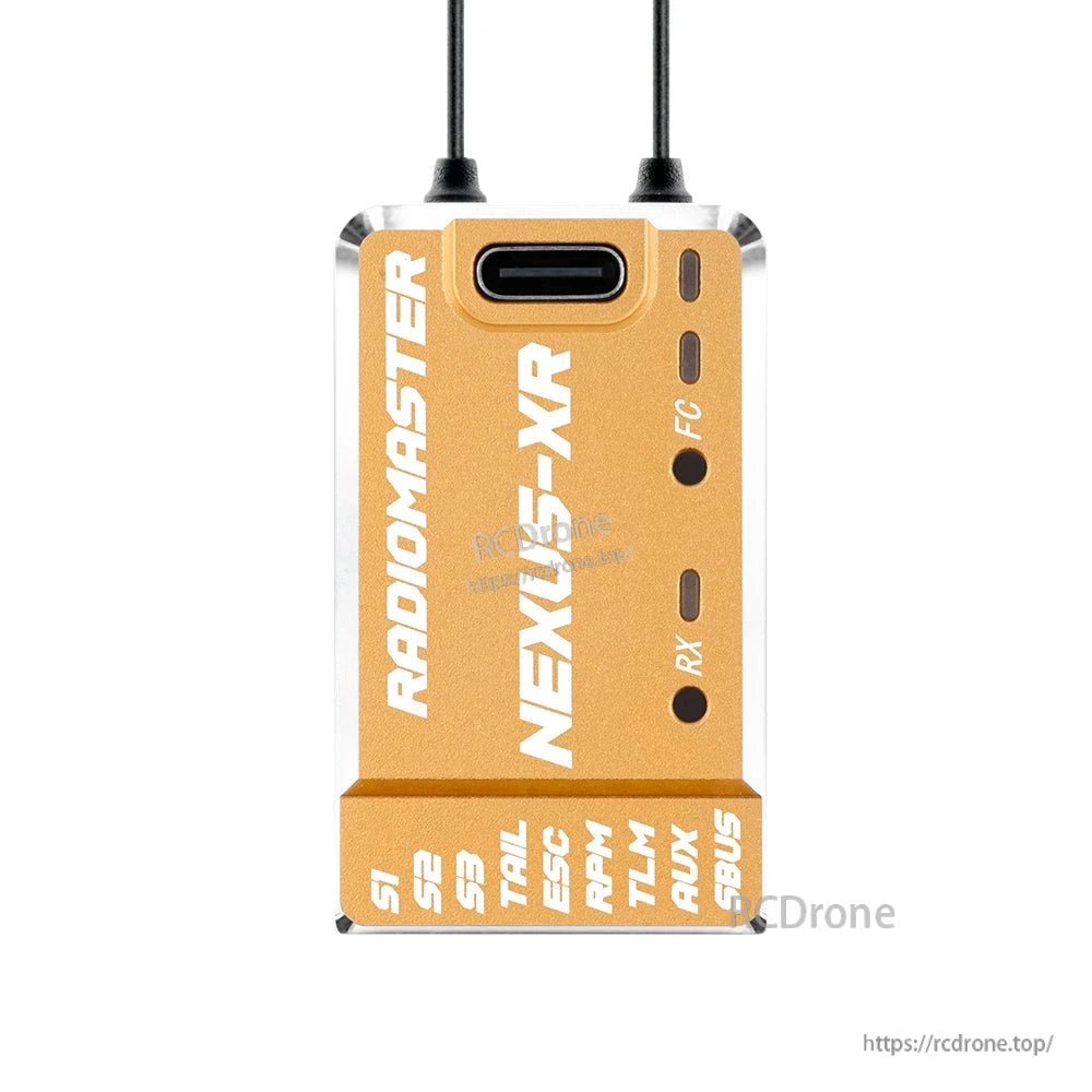 NEXUS-XR flight controller in gold housing, front face showing USB-C and labeled side cutouts