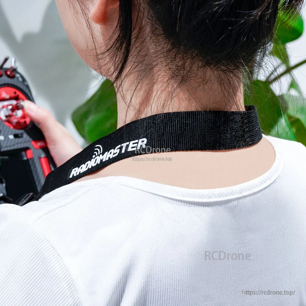 Neck strap worn around neck while holding RC transmitter, rear view showing RadioMaster logo