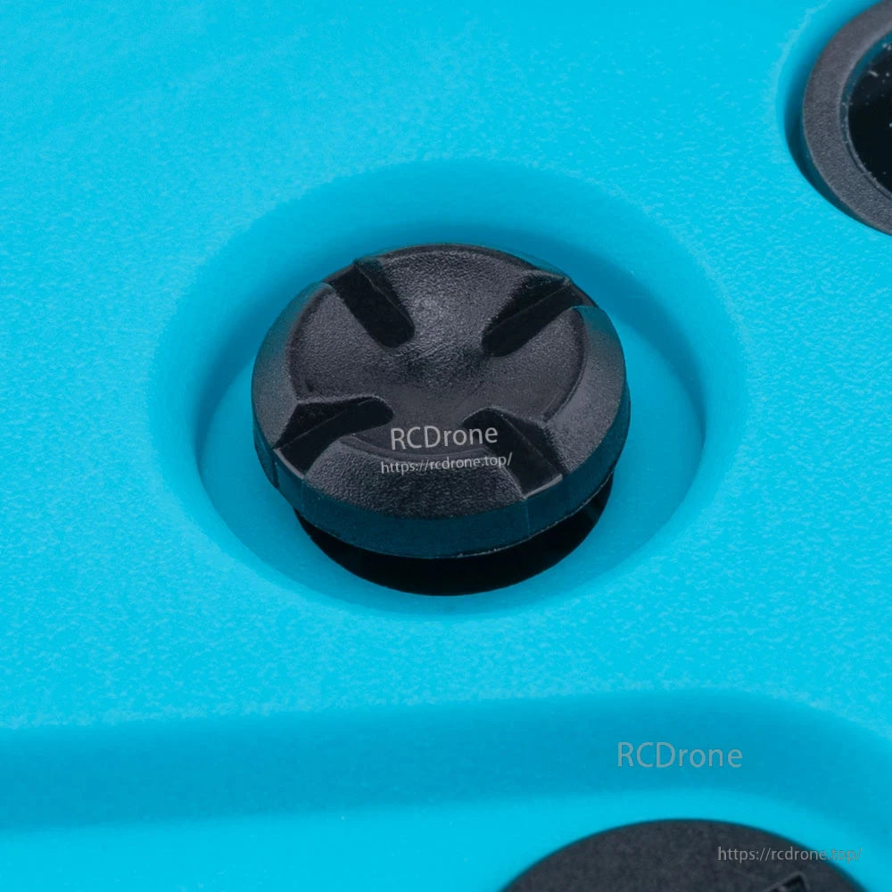 Close-up of front trim/navigation button on RadioMaster Pocket Crush transmitter body (blue)