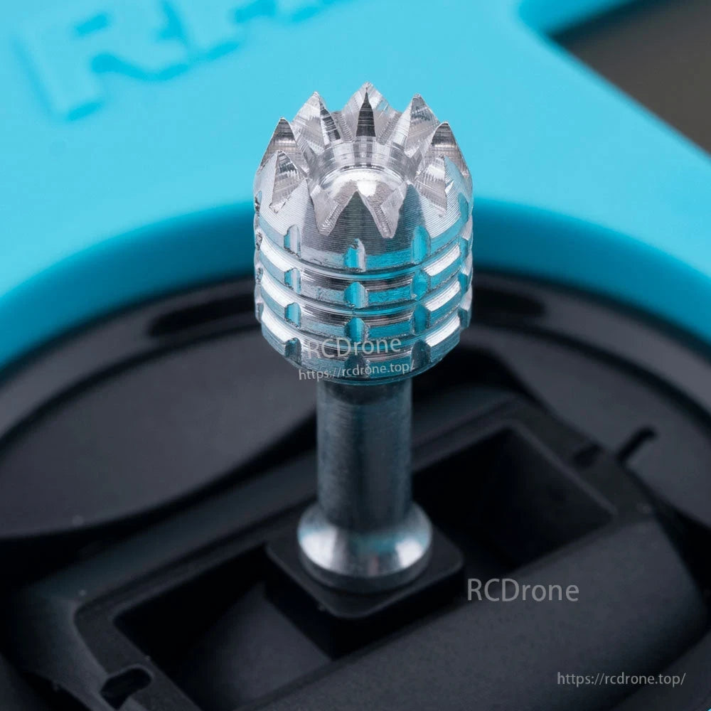 Close-up of RadioMaster Pocket Crush gimbal stick with metal thumb end cap on blue transmitter