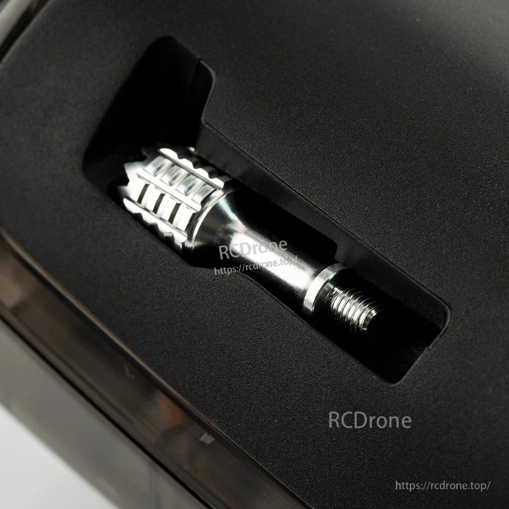 Gimbal stick stored in the radio body slot, showing threaded end and metal grip section